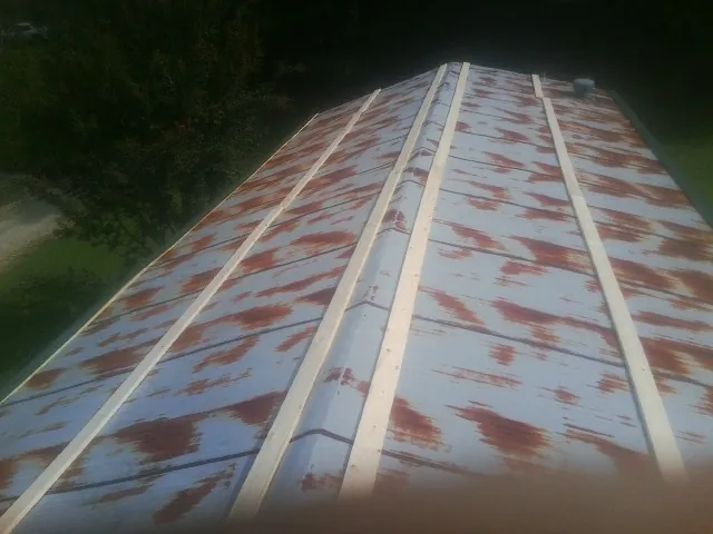 Rusted metal roof panels with new wood purlins before replacement — Storm Damage Roof Repair in Dillonvale by Roofing Brothers